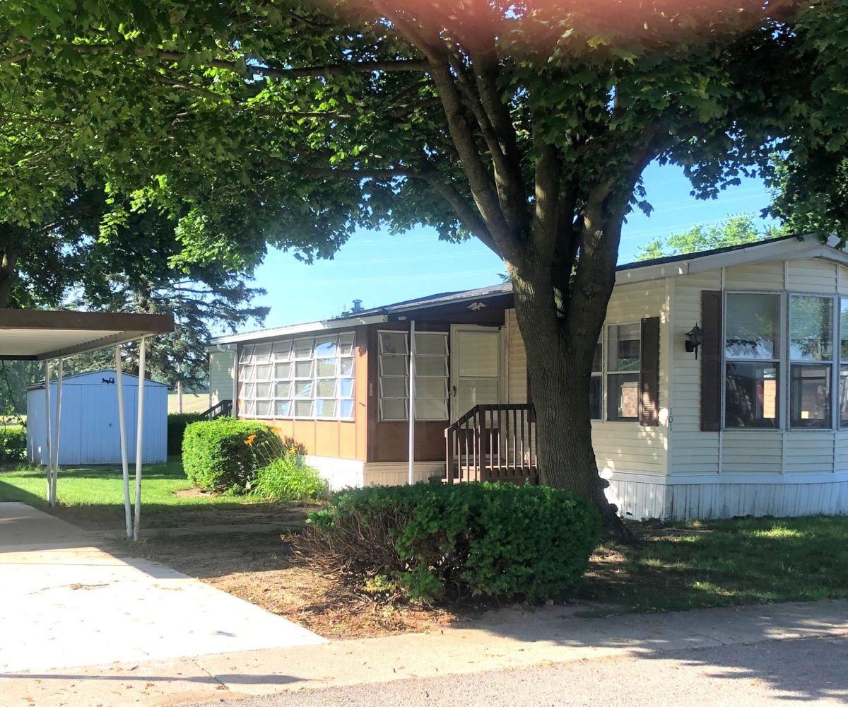 Retirement home with lot of windows for sale at Evergreen Estates in Jonesville, Michigan